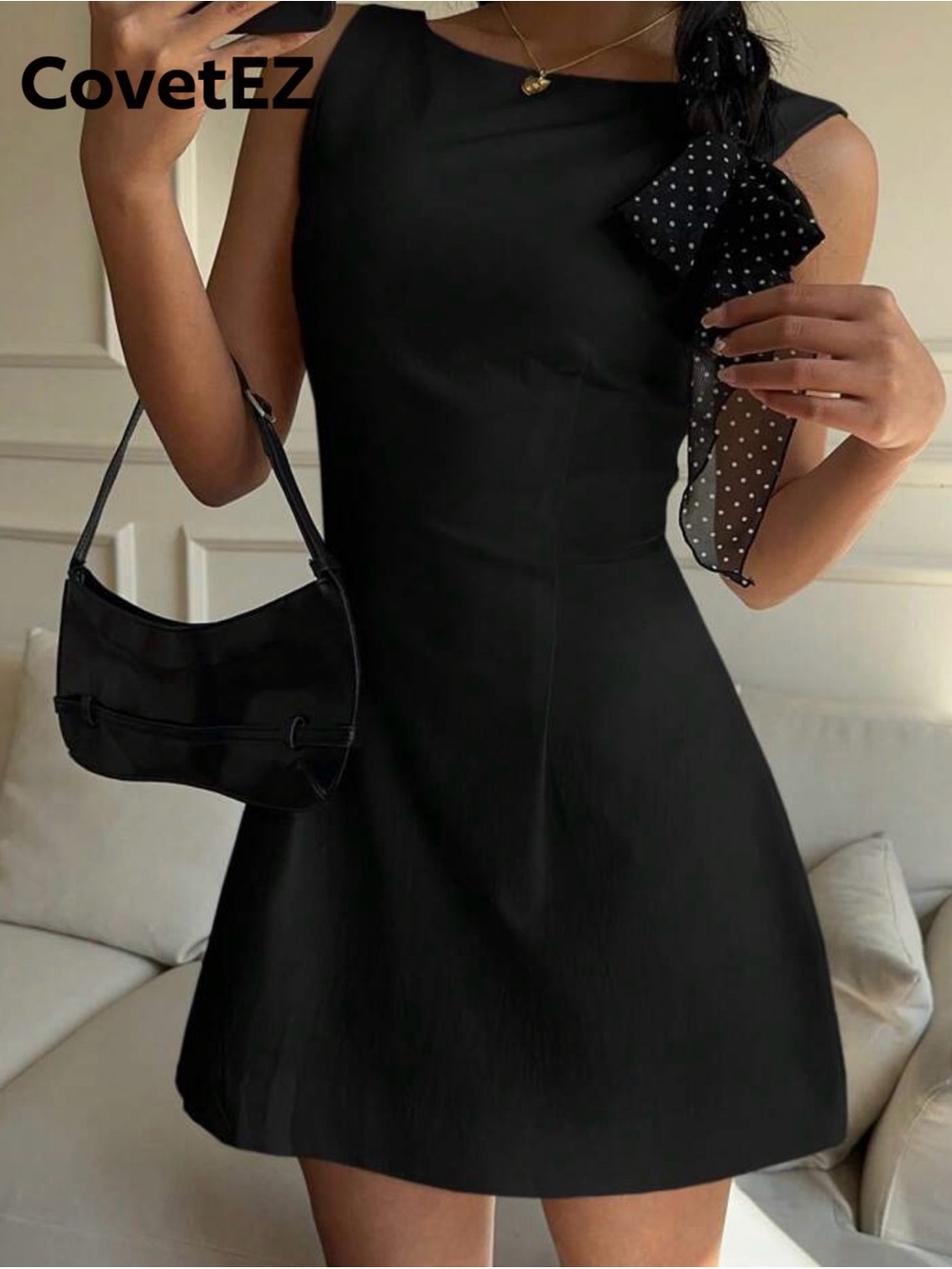 Cove Black Sleeveless Mini Dress with Polka-Dot Bow